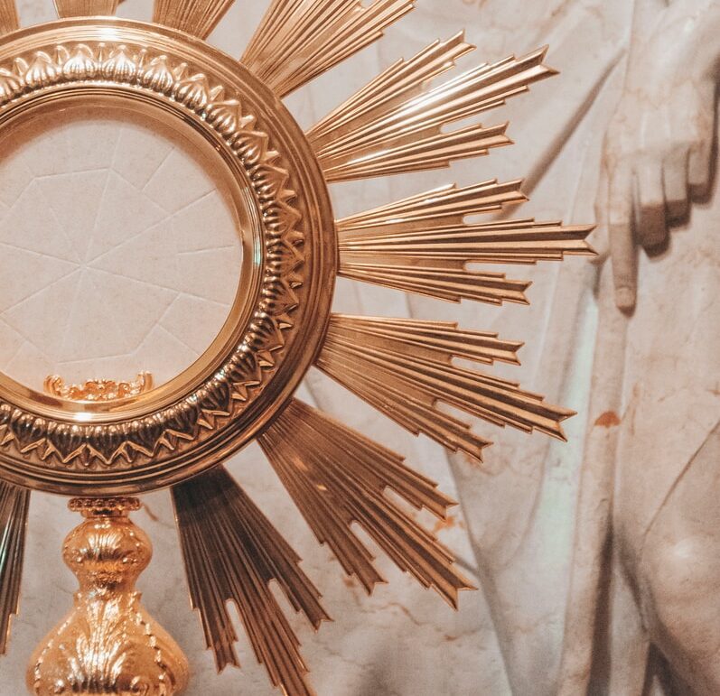 gold round framed mirror on white textile